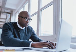 Man-Laptop-Serious-Window-300x207